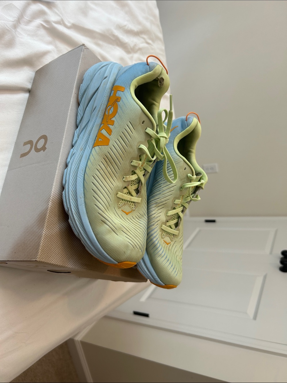 Hoka Light Green and Light Blue Running Shoes with Orange Accents